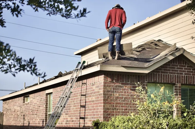 Professional roofer working on a residential roof in East Terrell Hills